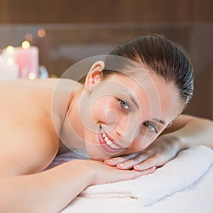 Beautiful woman lying on massage table at spa center