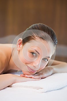 Beautiful woman lying on massage table at spa center