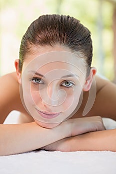 Beautiful woman lying on massage table at spa center