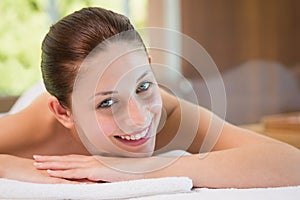 Beautiful woman lying on massage table at spa center