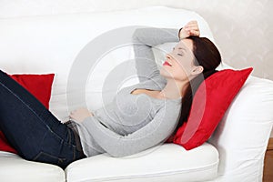 Beautiful woman lying on a sofa.