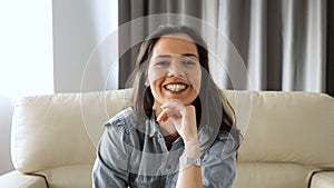 Beautiful woman lying on the sofa is standing to the front of the camera from out of focus to in focus