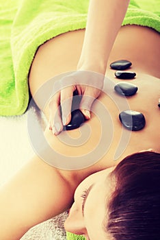 Beautiful woman lying on spa salon.