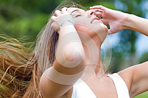 Beautiful woman with magnificent hair in the park