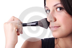 Beautiful woman with a make-up brush. Isolated