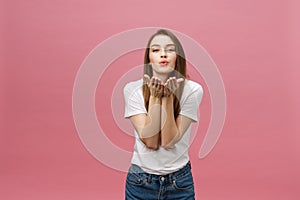 Beautiful woman with makeup and long blonde hair blows kiss, demonstrates her good feelings, says goodbye on distance