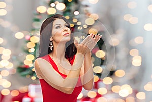 Beautiful woman making christmas wish over lights