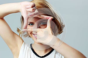 Beautiful woman making a hand frame