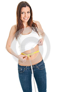 Beautiful woman measuring waist