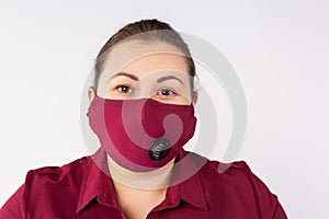 Beautiful woman in medical mask. Close-up of a young woman with a bordo surgical mask on her face against sars-cov-2. Portrait of