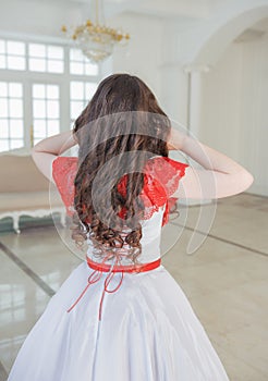 Beautiful woman in medieval dress with crinoline. Back pose