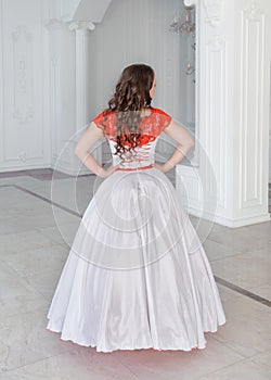 Beautiful woman in medieval dress with crinoline. Back pose