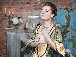 Beautiful woman in medieval dress received letter