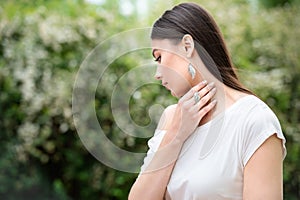 Beautiful woman model at the blooming spring garden with stylish accessory