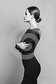 Beautiful woman model posing in elegant dress in the studio