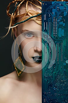 Beautiful woman with motherboard