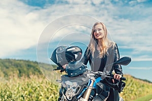 Beautiful woman on a motorcycle looking at the road ahead