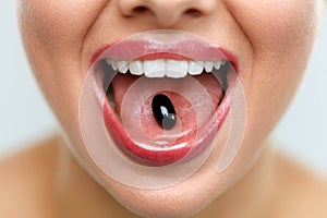 Beautiful Woman Mouth With Pill On Tongue. Girl Taking Medicine