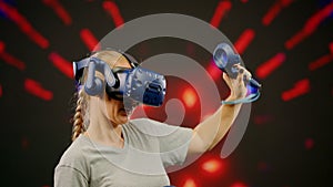 The beautiful woman moves activity in modern virtual reality dance game.Led screen with blur background.The woman