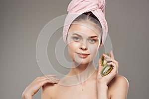 beautiful woman with naked body clean skin kiwi in hand cropped view