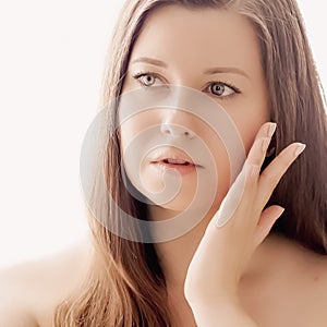 Beautiful woman with natural look, perfect skin and shiny hair as make-up, health and wellness concept. Face portrait of