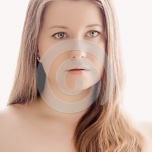 Beautiful woman with natural look, perfect skin and shiny hair as make-up, health and wellness concept. Face portrait of