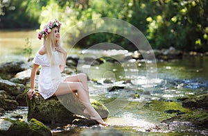 Beautiful woman near a mountain river