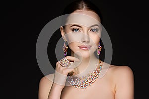 Beautiful woman in a necklace, earrings and ring. Model in jewel photo