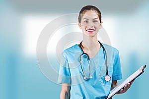 Beautiful woman nurse or doctor is holding a notepad board with copy space for  advertising