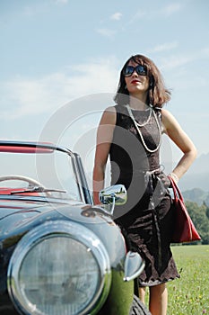 Beautiful woman and old car, sixties style