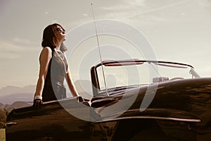 Beautiful woman and old car, sixties style