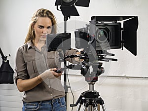 Beautiful woman operating a video camera rig