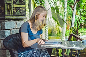 Beautiful woman ordering from menu in restaurant and deciding what to eat