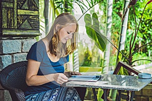 Beautiful woman ordering from menu in restaurant and deciding what to eat