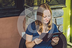 Beautiful woman ordering from menu in restaurant and deciding what to eat