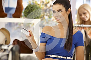 Beautiful woman paying by credit card