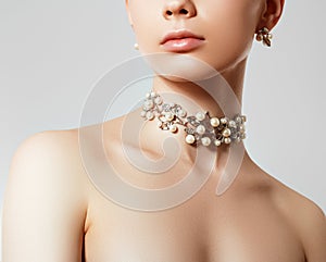 Beautiful woman with Pearl Necklace. Young beauty model with pearl pendant and earrings. Jewellery and accessories