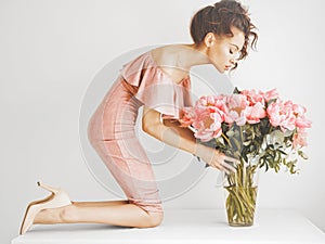 Beautiful woman with peonies