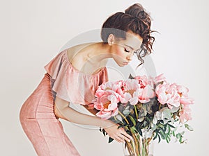 Beautiful woman with peonies