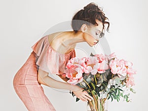 Beautiful woman with peonies