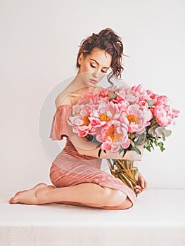 Beautiful woman with peonies