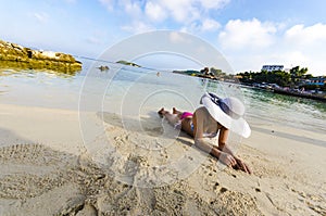 Beautiful woman with perfect body lying down on the beach