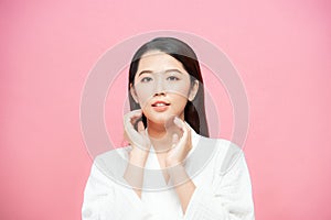 Beautiful woman with perfect makeup on pink background. Beauty and skin care concept