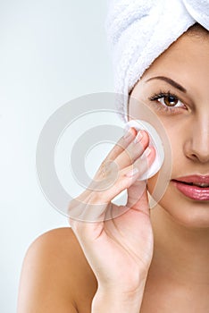 Beautiful woman with perfect skin clean face towel on her head