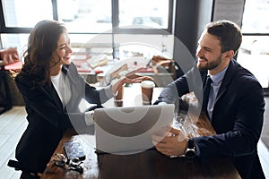 Beautiful woman persuading handsome bearded man to cooperate