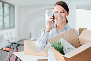 Beautiful woman on the phone with an open box