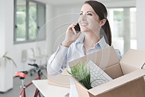 Beautiful woman on the phone with an open box