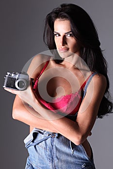Beautiful woman photographer holding retro camera
