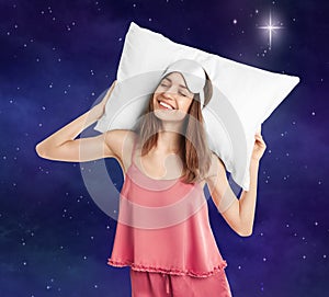 Beautiful woman with pillow and night sky moon on background. Bedtime