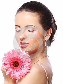 Beautiful woman with pink flower isolated on white